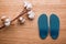 Cotton branch and orthopedic insoles on a wooden table