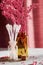 Cotton buds and cosmetic jars on the makeup desk with decorative scented flowers