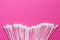 cotton buds on pink background. Cosmetic concept with copy space. Medicine and personal hygiene