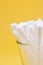 Cotton buds yellow background