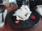 Cotton candy baked Alaska dessert on a black plate