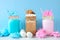 Cotton candy and smores summer milkshakes in mason jar glasses against a pastel blue background