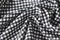 Cotton fabric natural and has a soft ripple. Grid pattern black and white and rough surface background.