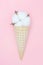 Cotton flower in an ice cream waffle cone. The concept of softness, beauty and taste. Pink background. Blog about life