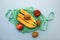 Cotton green string bag with fruits kiwi, banana, peach on blue background