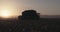 Cotton harvester harvesting in a cotton field during sunset