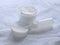 Cotton hygienic pads, small bottle against a background white terry towel.