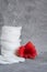 Cotton pads on a gray background, a red flower on a gray background, the concept of skin cleansing, cosmetics, eco cosmetics, skin