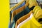 Cotton and sports t-shirts hung on wall hanger racks inside a clothes shop low angle view with the focused depth of field