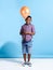 This could be my new best friend. a young boy holding a balloon over a blue background.