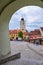 The Council Tower Turnul Sfatului seen from under an arch of Arts House - Butchers Guild Hall in Sibiu, Romania - vertical.