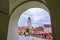 The Council Tower Turnul Sfatului seen from under a passage arch of Arts House - Butchers Guild Hall in Sibiu - horizontal