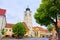 The Council Tower Turnul Sfatului in Sibiu, seen from the main large square, with green trees on overcast day.