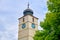 The Council Tower Turnul Sfatului in Sibiu Small Square Piata Mica - top part with a green tree, on a bright day.