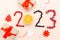 Countdown to New Year.2023 lettering number shaped with sweet fresh raspberry, currant,berry on pink background