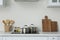 Counter with set of dishware and utensils in kitchen interior