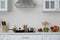 Counter with set of dishware, utensils and products in kitchen interior