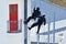 Counter-terrorism police officers abseiling a building