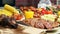 A counter with trays containing grilled sausages and meat. Round barbecue sausage street food showcase. Freshly grilled