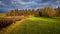 Countriside landscape in the evening light with clouds in the sk