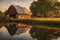 country barn reflected in a serene pond