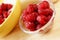 A country breakfast with pile of ripe raspberries, and porridge