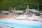 Country club recreation recreation relax pool wooden house forest trees sun lounger umbrella.