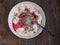 Country cottage cheese with cereals and fruit jam in a ceramic plate