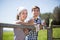 Country couple of farmers drink milk in field near fenc