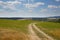 Country dirt road through farmlands