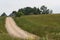 Country dirt road with old abandon house.