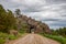 Country dirt road passing through a rock tunnel