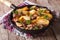 Country fried potatoes with meat and bacon in a pan closeup. hor