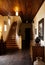 Country house hallway with stairwell and wood furniture