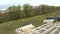 Country house of straw bales construction. Truck unloads construction blocks, time-lapse