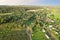 Country houses in the countryside. Aerial view of roofs of green field with rural homes. Village with wooden home. Suburban house