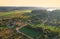 Country houses in the countryside. Aerial view of roofs of green field with rural homes. Village with wooden home. Suburban house