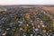 Country houses in the countryside. Aerial view of roofs of green field with rural homes. Village with wooden home. Suburban house