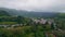 Country houses mountain valley landscape aerial view. Gloomy green hills village