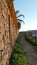 Country path below honeysuckle covered wall on the outskirts of Andalusian village