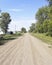 Country road. Abandoned street. Ruined houses. Void in the village. People left their place of residence.