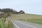country road across a hill in the Eifel during April