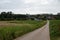 Country road through the agriculture fields at the village Ossel, Brabant, Belgium