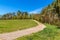 Country road along the forest. Landscape of the Czech countryside. Farm farm. Dirt road