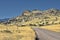 Country road curves gently uphill in Montana