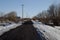 Country road in early spring. a man in the distance does a jog