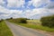 Country road and farm gate in summertime