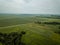 country road in green forest and fields drone aerial image