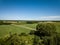 country road in green forest and fields drone aerial image