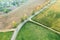 Country road intersection with dirt roads between agricultural fields. autumn landscape. drone photo